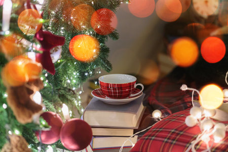Plaid Cup and Books Under Christmas Treeの写真素材