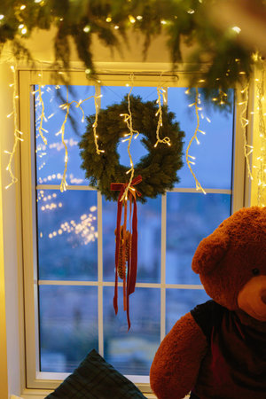 Window Wreath with Glowing Lights and Teddy Bearの写真素材