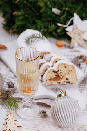 Festive champagne glass with holiday cookies and stollenの写真素材