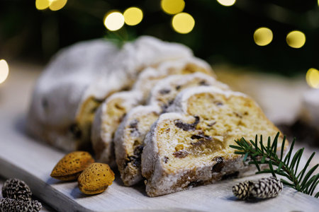 Traditional Christmas stollen on a festive wooden boardの写真素材