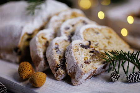 Festive Christmas stollen with glowing lights and pinecones