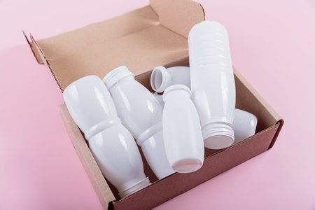 White plastic bottles placed in a cardboard boxの写真素材