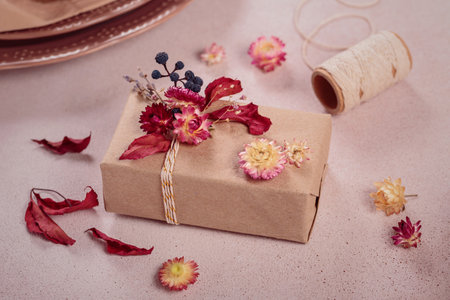 Process of wrapping and decorating presents with dried flowersの写真素材