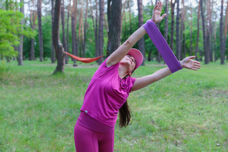 Woman training with a resistance band outdoorsの写真素材