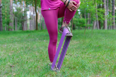 Woman lifting a resistance band during workoutの写真素材
