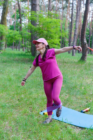 Woman doing a balance exercise with a resistance bandの写真素材