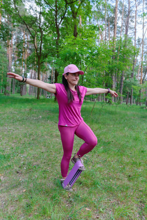 Woman performing a balancing exercise with a resistance bandの写真素材