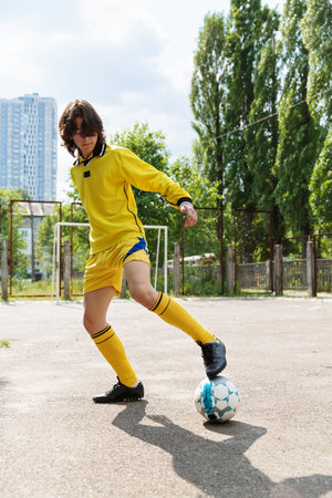 Teenage footballer practicing foot skillsの写真素材