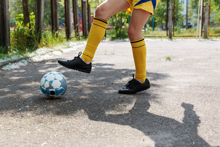 Soccer player dribbling the ball on the fieldの写真素材