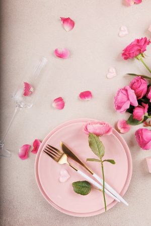 Beautiful Valentines Day table with pink roses and delicate decorの写真素材
