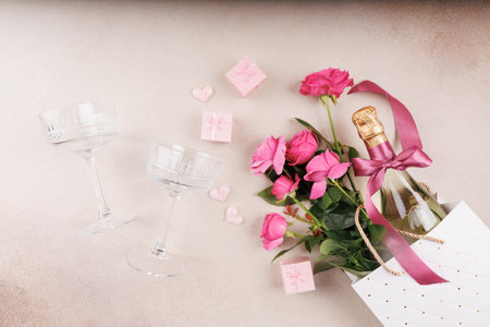Pink roses, champagne, and heart decorations for a romantic celebrationの写真素材