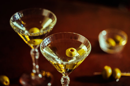 Two Classic Martinis with Olives on a Stylish Bar Counterの写真素材