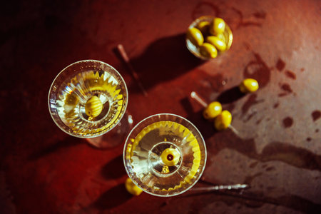 Top-Down View of a Martini with Olives and Elegant Bar Toolsの写真素材