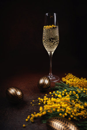 Easter celebration with champagne, mimosa, and golden eggsの写真素材