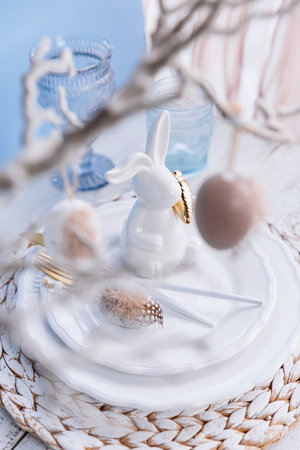 Table place setting with bunny figure and eggsの写真素材