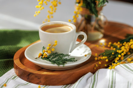 Rustic coffee moment with mimosa flowers in natural lightの写真素材