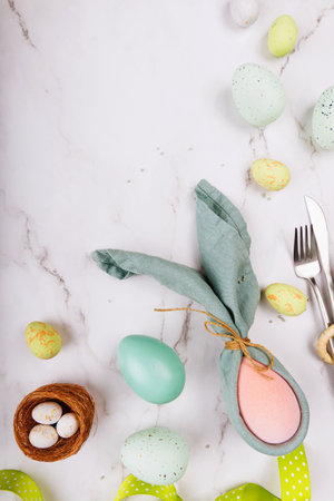 Vertical Easter Scene with Pastel Eggs and Napkin Bunnyの写真素材