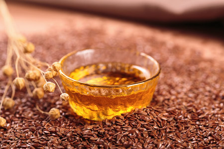 Brown linen seeds, flaxseed vegetable oil on beige backgroundの写真素材