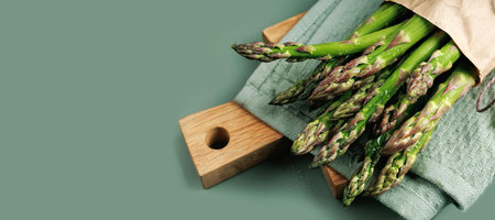 Fresh Asparagus on Towel and Wooden Boardの写真素材