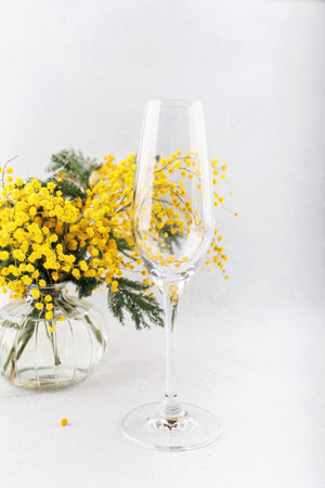Champagne flute with mimosa flower reflection .の写真素材