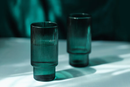 Elegant Green Water Glass with Reflectionsの写真素材