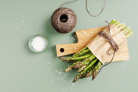 Fresh Organic Asparagus with Ceramic Salt Bowl and Kitchen Stringの写真素材