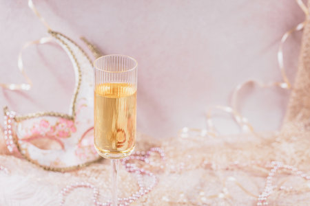 Masquerade ball holiday background with sparkling wineの写真素材