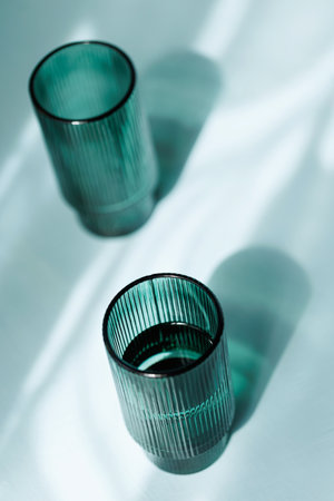 Elegant Green Tumblers in Light and Shadowの写真素材