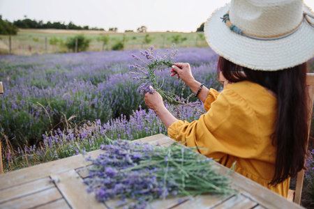 Woman making lavender wreath in peaceful countrysideの写真素材