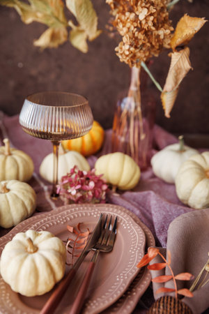 Cozy Thanksgiving table setting with rustic fall decorationsの写真素材