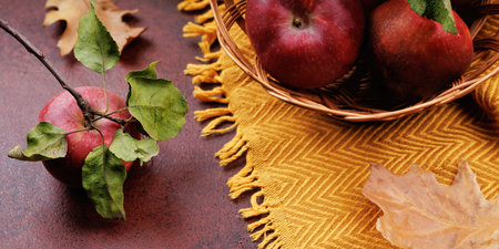 Red Apple with Green Leaves on Rustic Tableの写真素材