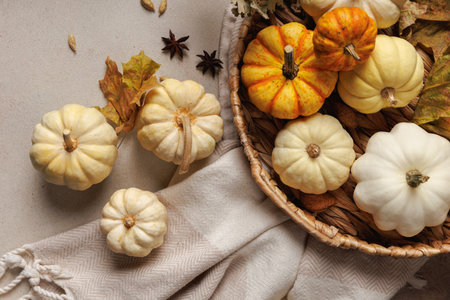 Thanksgiving pumpkins in basket with autumn leaves and spices..の写真素材