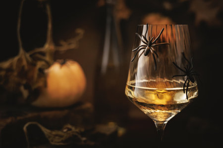 White Wine Glass with Spiders in Halloween Settingの写真素材