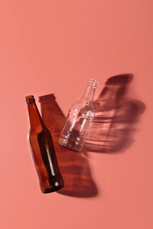 Top view of two glass bottles with shadows on pastel backgroundの写真素材
