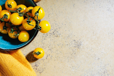 Above view of heirloom cherry tomatoes with yellow towel..の写真素材