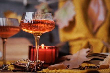 Rose Drink in Glass with Autumn Candle and Spicesの写真素材