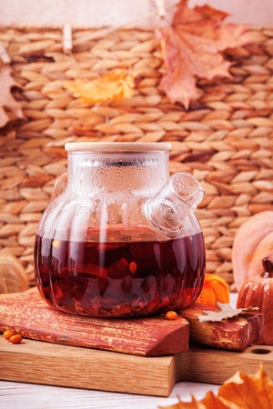 Warming Sea Buckthorn Tea in Autumn Teapotの写真素材