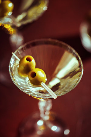 Festive Martini with Green Olives and Sparkling Bokehの写真素材