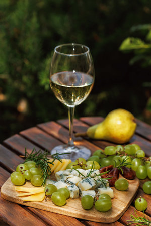Chilled White Wine and Fresh Grapes in Garden Ambienceの写真素材