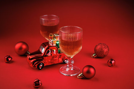Whiskey glasses with red Christmas toy car and baublesの写真素材
