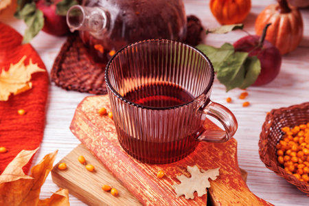 Hot Herbal Tea with Autumn Fruit and Leavesの写真素材