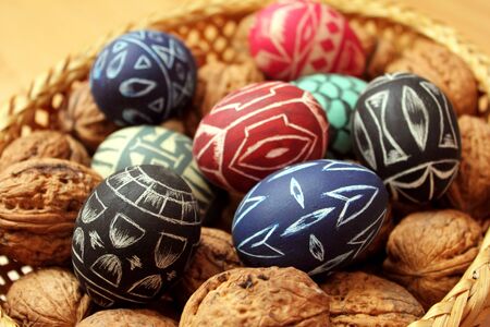 easter eggs and walnuts in basketの写真素材