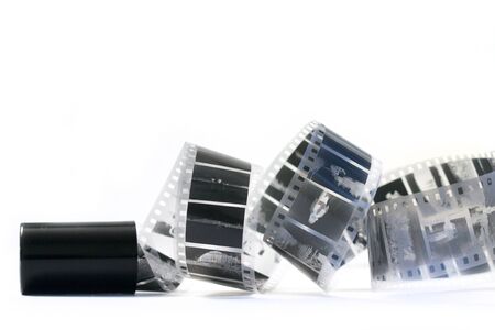 Film roll and spiral of black and white negative film on white bの写真素材