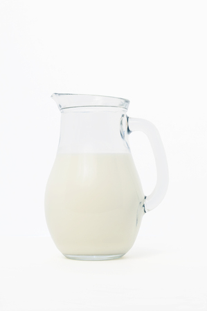 glass jug with milk, on white backgroundの写真素材