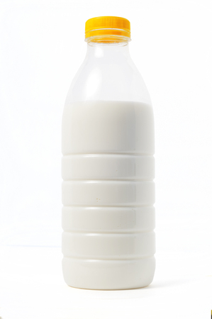 Plastic bottle of milk with a colored cap, white background, isoの写真素材