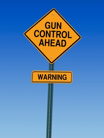 gun control ahead warning roadsign over blue skyの写真素材