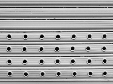 light grey painted perforated roll up gates background                               の写真素材