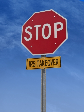 stop irs takeover conceptual road sign over skyの写真素材