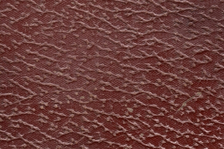 vintage stained bumpy grained dark red leather backgroundの写真素材