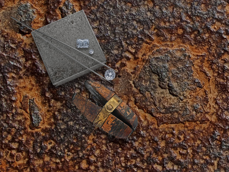 old working rusty plate with diamonds, anvil and jewelery viseの写真素材